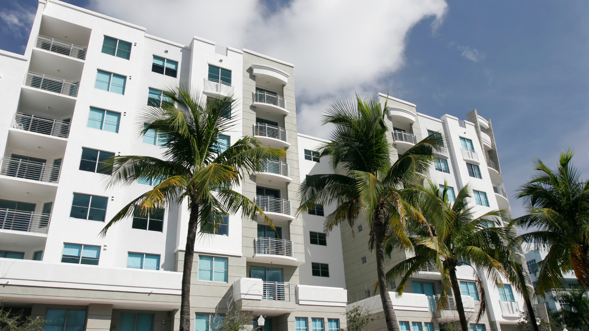 Condo building with palms representing VA-approved condo searches in Southern California