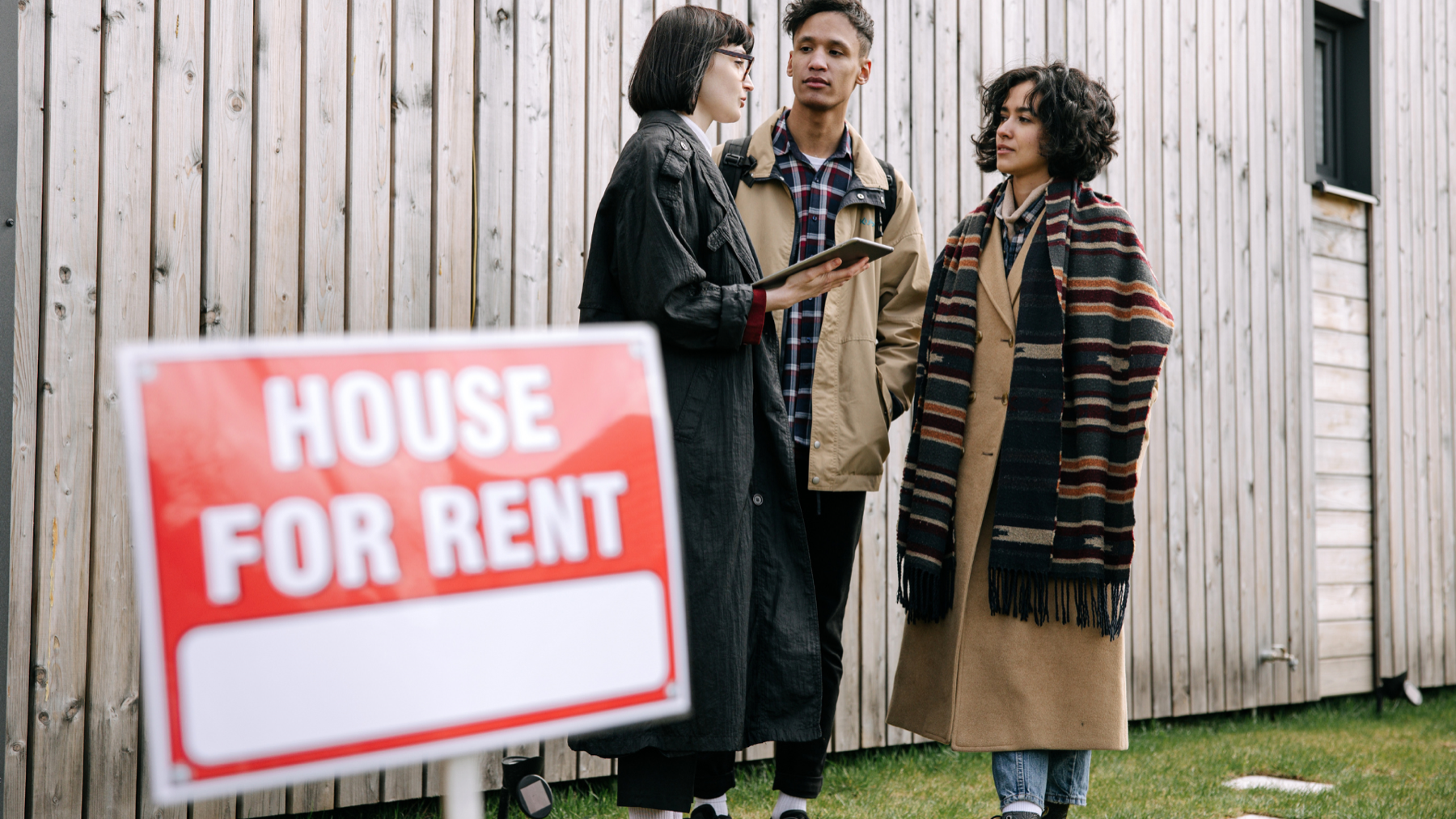 Rental sign and prospective tenants for a Long Beach owner deciding whether to sell or rent before moving out of state